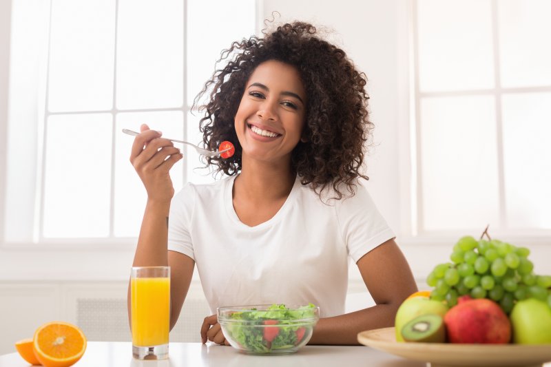 Fresh foods on a plate with a toothbrush, representing a healthy diet for strong teeth